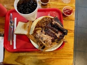 A table displaying a tray with an assortment of food and beverages.