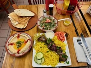 A dining table adorned with an assortment of food plates and beverages, inviting for a shared meal experience.
