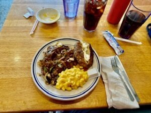 A table set with a plate of food and drinks, showcasing a casual dining arrangement.