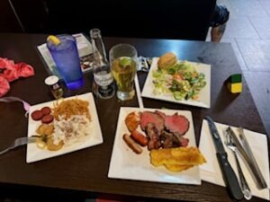 A table set with various plates of food and drinks, showcasing a colorful and appetizing spread for a meal.