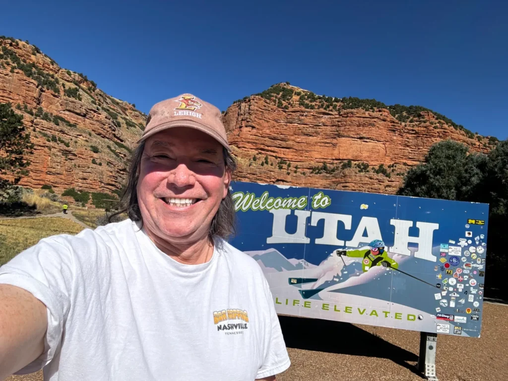 Romulo Perez-Segnini taking selfie for UTAH sign board