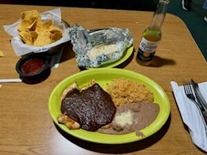 A table set with various dishes and drinks, showcasing a colorful spread of food for a gathering.