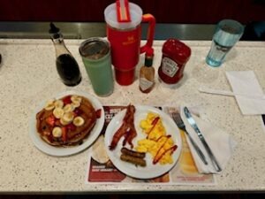 A beautifully arranged breakfast table featuring an assortment of dishes and beverages for a festive dining experience.